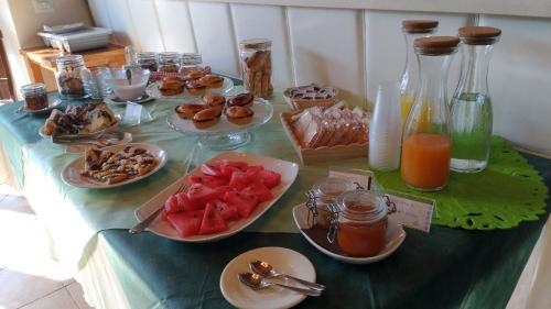 a table with plates of food and drinks on it at Agriturismo Arangèa in Lequile