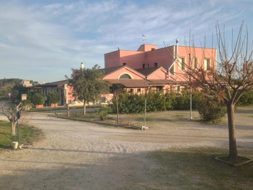 a large building with a road in front of it at Agriturismo Arangèa in Lequile
