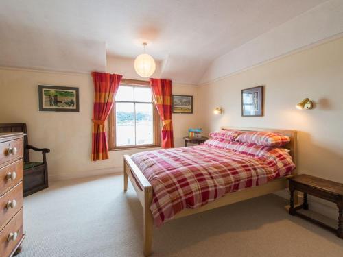 a bedroom with a bed and a window at Glan Y Mor, 147 Station Road in Deganwy