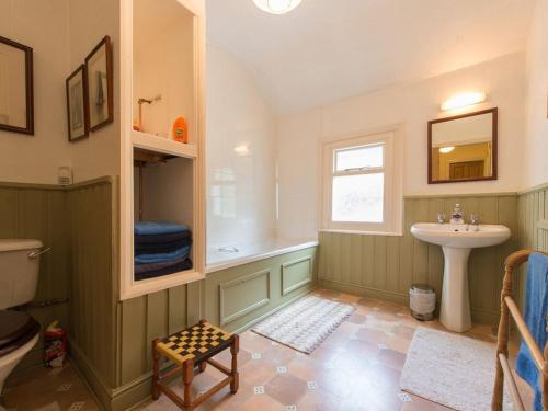 a bathroom with a sink and a tub and a toilet at Glan Y Mor, 147 Station Road in Deganwy