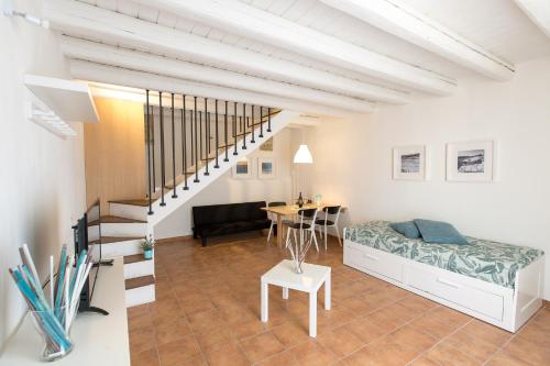 a living room with a bed and a table at Residence Ortigia in Siracusa