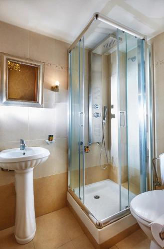 a bathroom with a shower and a sink at Archontiko Old Town Suites in Rethymno Town