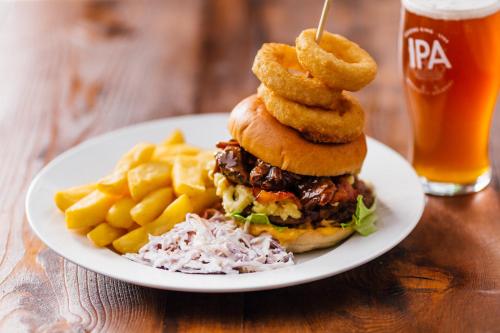 a plate of food with a sandwich and onion rings at Windmill Farm Lincoln by Greene King Inns in Lincoln