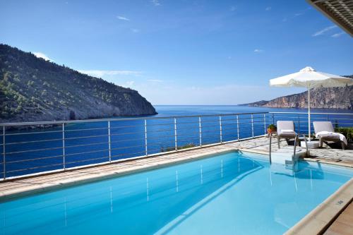 a swimming pool with a view of the ocean at Braunis Horio Villas in Asos