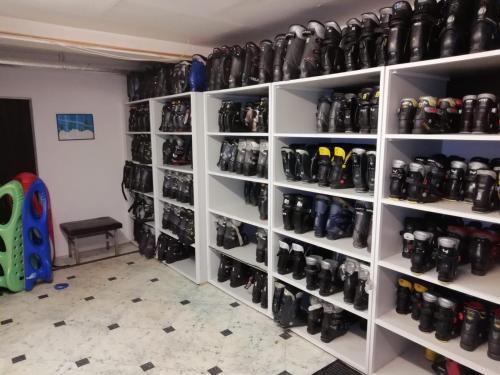 a room with shelves filled with lots of shoes at Hotel Winterberg Resort in Winterberg