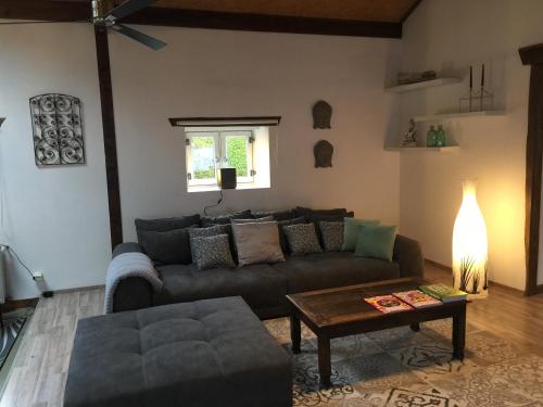 a living room with a couch and a table at Hof Busen Loft in Mönchengladbach