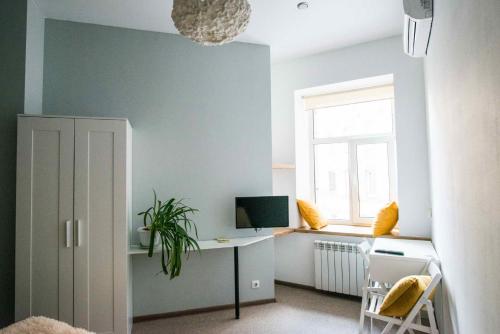 a room with a desk with a computer and a window at Loft on Sadovaya in Saint Petersburg