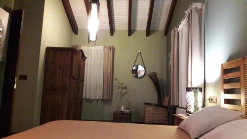 a bedroom with a bed and a window at La Casona de Palu in Pola de Laviana