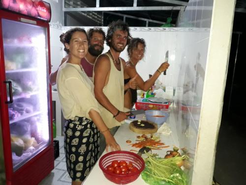 a group of people standing in front of a refrigerator at Flower & Frog Homestay in Sa Ðéc