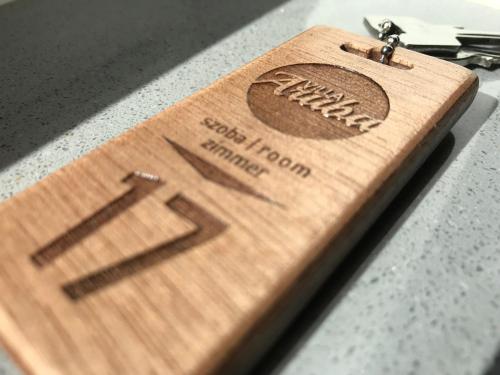a wooden key chain with a baseball on it at Villa Aruba & Private SPA Suites in Keszthely