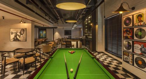 a pub with a pool table in a room at Lemon Tree Premier City Center Pune in Pune