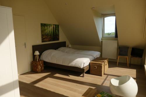 a small bedroom with a bed and a window at La Garonde in Berthen