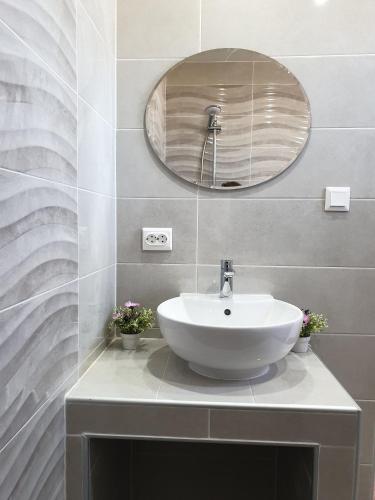 a bathroom with a sink and a mirror at Apartments Elena in Ugljan