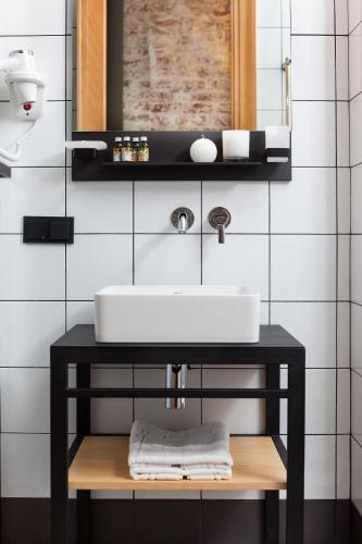 a bathroom with a sink and a mirror at Ribas Rooms Ferenc Lviv in Lviv