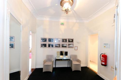 a room with a table and chairs and a fire extinguisher at Aparthotel York in Hamburg