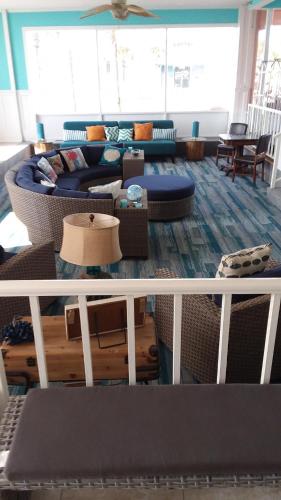 a living room with a couch and a table at Fountain Beach Resort - Daytona Beach in Daytona Beach
