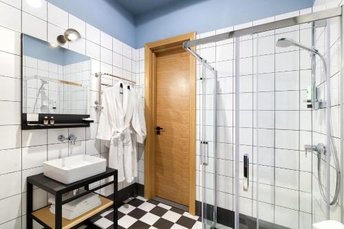 a bathroom with a shower, sink, and toilet at FERENC Hotel & Restaurant in Lviv