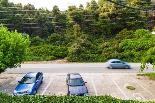 two cars parked on the side of a road at F & B Summer Collection - Kassandra - Mola Kaliva in Mola Kalyva
