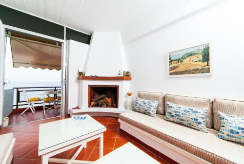 a living room with a couch and a fireplace at F & B Summer Collection - Kassandra - Mola Kaliva in Mola Kalyva