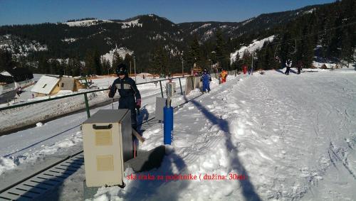 a person standing on a snow covered ski slope at Eko-FIS Vlašić in Vlasic