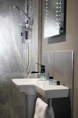 a bathroom with a sink and a shower at The Peacock in Bakewell
