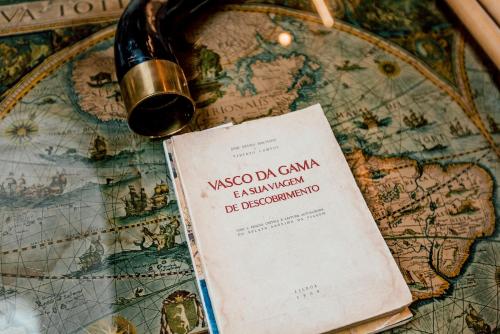 a bottle of wine sitting on top of a map at Torel 1884 Suites & Apartments in Porto