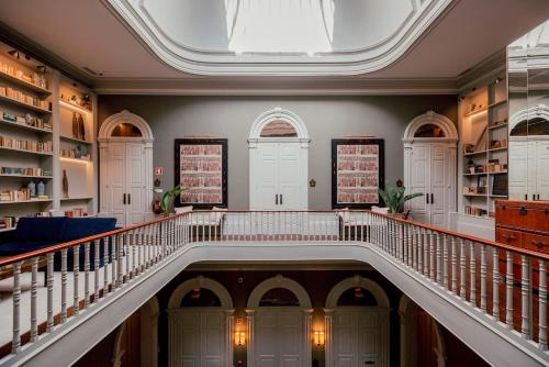 a large hallway with a staircase in a building at Torel 1884 Suites & Apartments in Porto