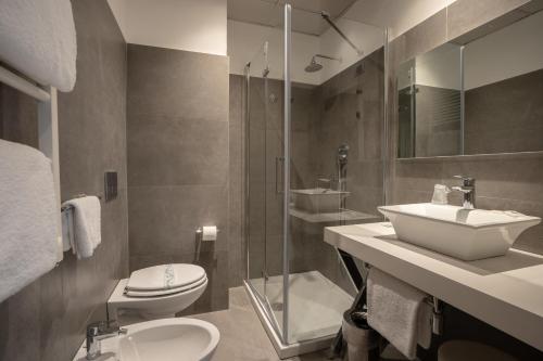 a bathroom with a sink and a toilet and a shower at Hotel Poledrini in Foligno