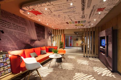 a living room with a couch and a table at ibis Cherbourg La Glacerie in Cherbourg en Cotentin