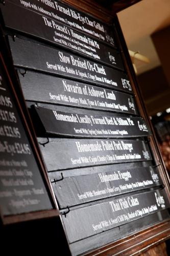 a bunch of black signs with white writing on them at The Peacock in Bakewell