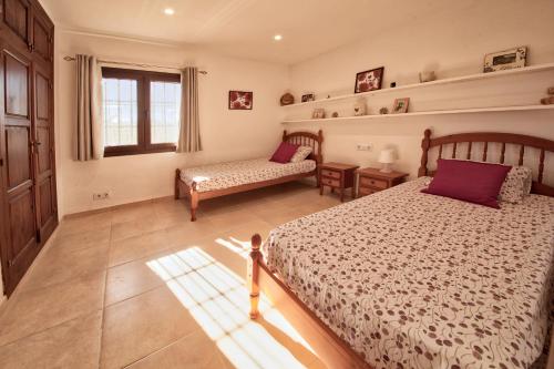 a bedroom with two beds and a window at Los Arcos, Javea in Jesus Pobre
