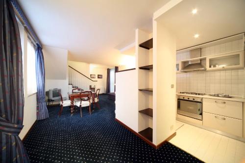 a kitchen and dining room with a table at Aldrovandi Residence City Suites in Rome
