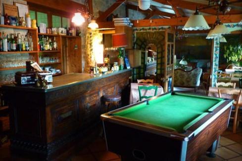 a bar with a pool table in front of a bar at Beau Site Guimauve et Vieilles Dentelles in Royères-Saint-Léonard