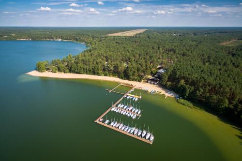 an island with a group of boats in the water at Largo Lake Resort Kaszuby in Borsk