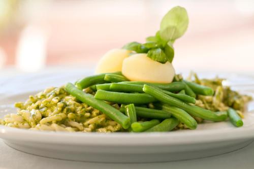 a plate of food with green beans and eggs at Europa Hotel Design Spa 1877 in Rapallo