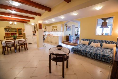 a living room with a couch and a table at Villa Zupan with Hot Tub in Škocjan