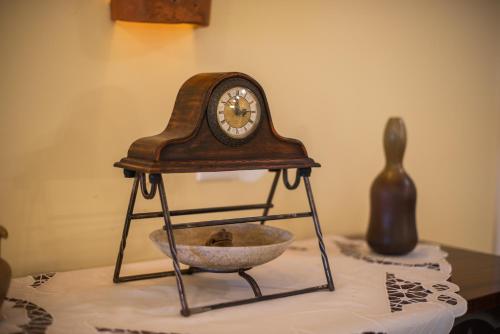 a clock and a bowl on a table at Villa Zupan with Hot Tub in Škocjan