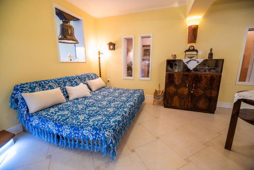 a living room with a bed and a dresser at Villa Zupan with Hot Tub in Škocjan