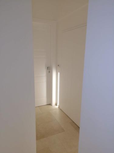 an empty room with white walls and a hallway at La Volta Buona in Matera