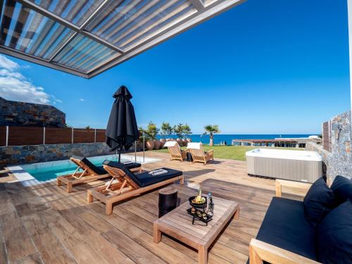 a patio with furniture and a swimming pool at Abaton Island Resort & Spa in Hersonissos