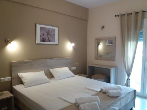 Postel nebo postele na pokoji v ubytování Dimitriou Rooms