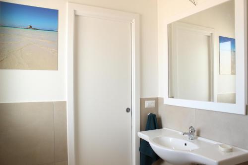 a bathroom with a sink and a mirror at 197 Pozzo San Nicola in Stintino