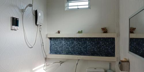 a bathroom with a shower and a toilet and a phone at Jazepuri - Jaze 3 in Kuching