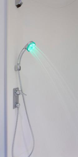 a shower with a shower head in a bathroom at ibis budget Cherbourg - La Glacerie in Cherbourg en Cotentin