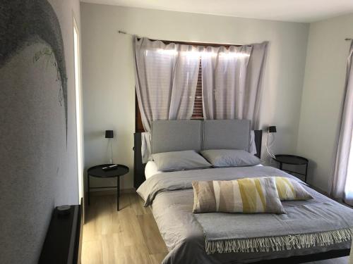 a bedroom with a large bed with a window at Al Grottino in Gambarogno
