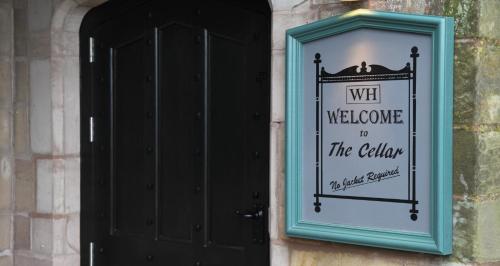 a sign on the side of a building with a window at Weston Hall in Stafford