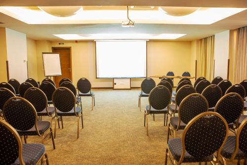 a conference room with chairs and a projection screen at Europa Royale Bucharest in Bucharest