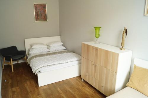 a small bedroom with a bed and a dresser at Apartmány Mary in Litoměřice