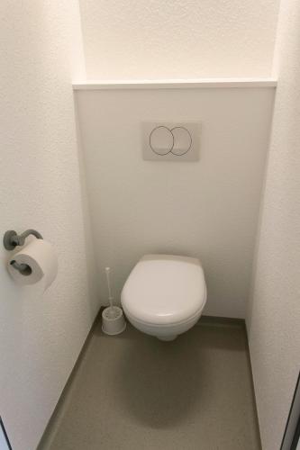 a small bathroom with a toilet in a stall at ibis budget Cherbourg - La Glacerie in Cherbourg en Cotentin