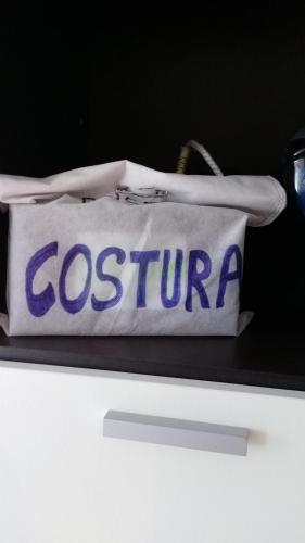 a bag with the word costron on it on a shelf at Apartamento ÉLITE en Cullera playa San Antonio in Cullera